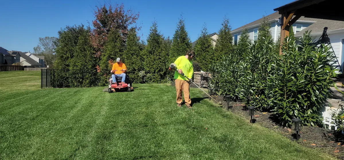 Landscaper mowing a residential lawn