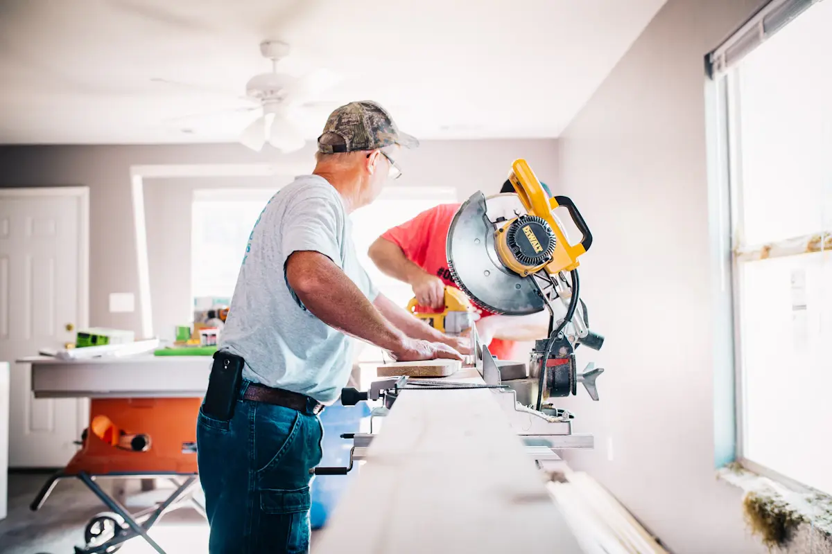 General contractor at a miter saw on a renovation site
