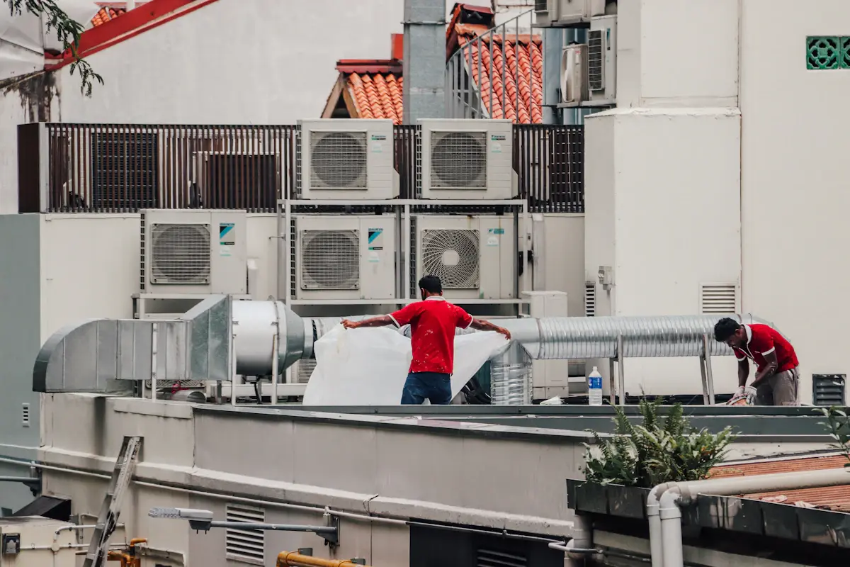 HVAC technicians working on a rooftop mechanical unit