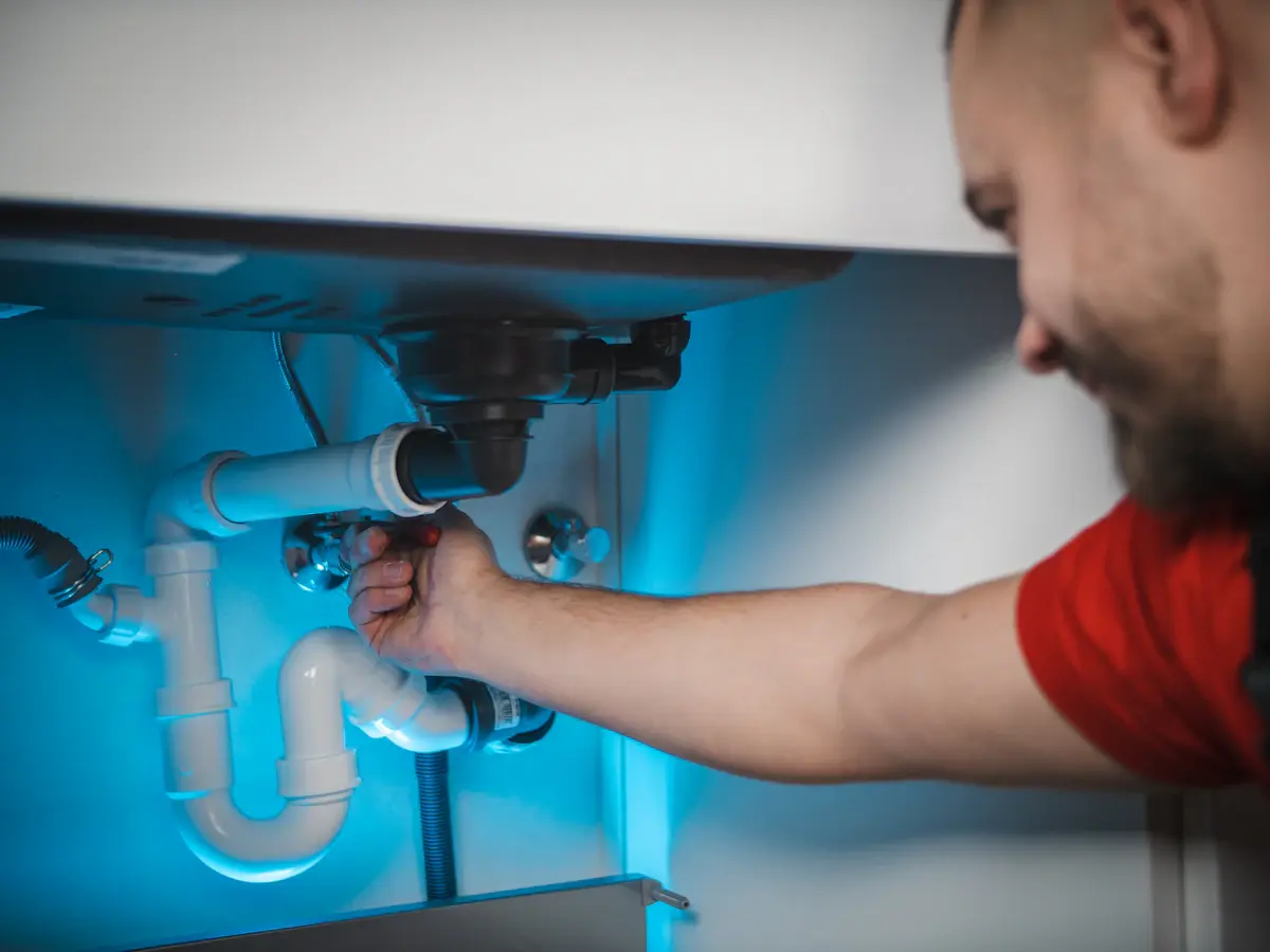 Plumber repairing a water heater in a residential property